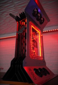 Side angle of MAXIMUS showcase PC build by MP-Customized illuminated in red lighting with futuristic tower shape