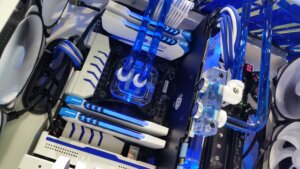 Close-up of Tri-MAX water cooling system by MP-Customized with blue liquid tubing and custom cabling