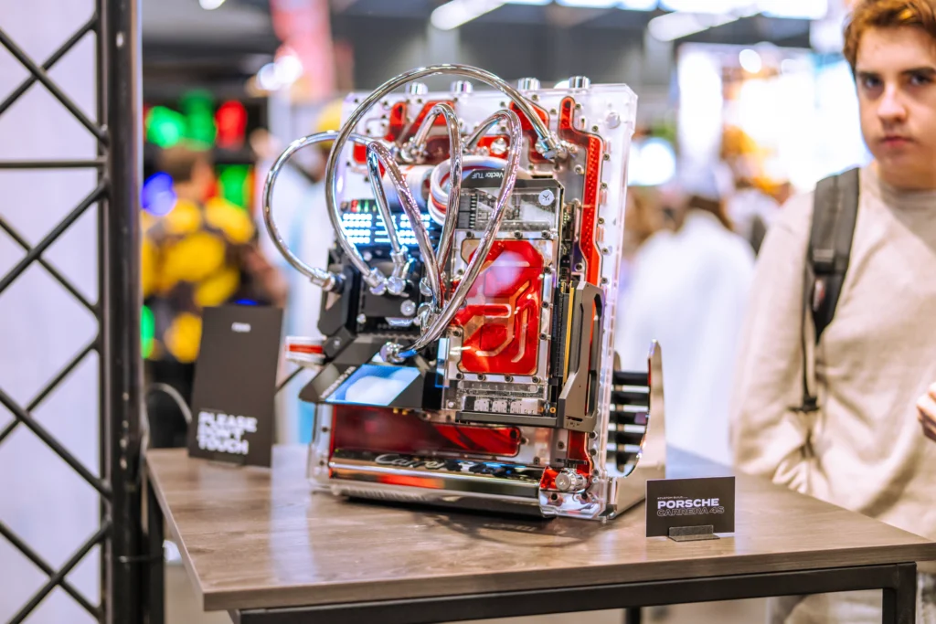 Porsche-themed water-cooled PC build using a Seasonic PSU, showcased at FACTS 2025.