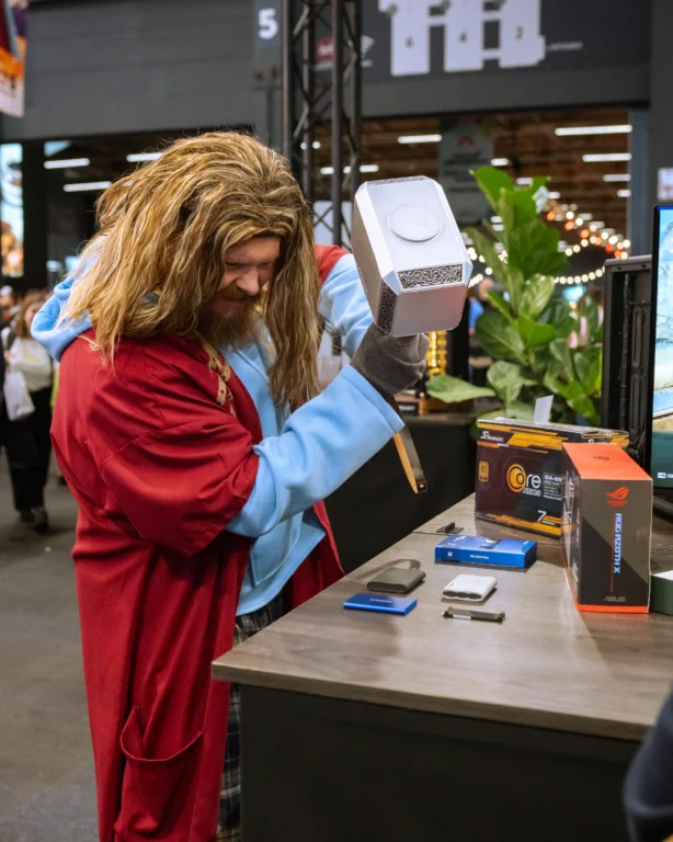 FACTS 2025 visitor in Thor cosplay interacting near the Seasonic-powered builds at the FENN booth.