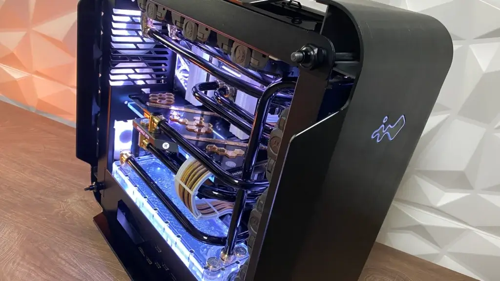 Close-up of the Black Gold water-cooled PC mod featuring chrome tubing, gold accents, and a Seasonic-powered setup.
