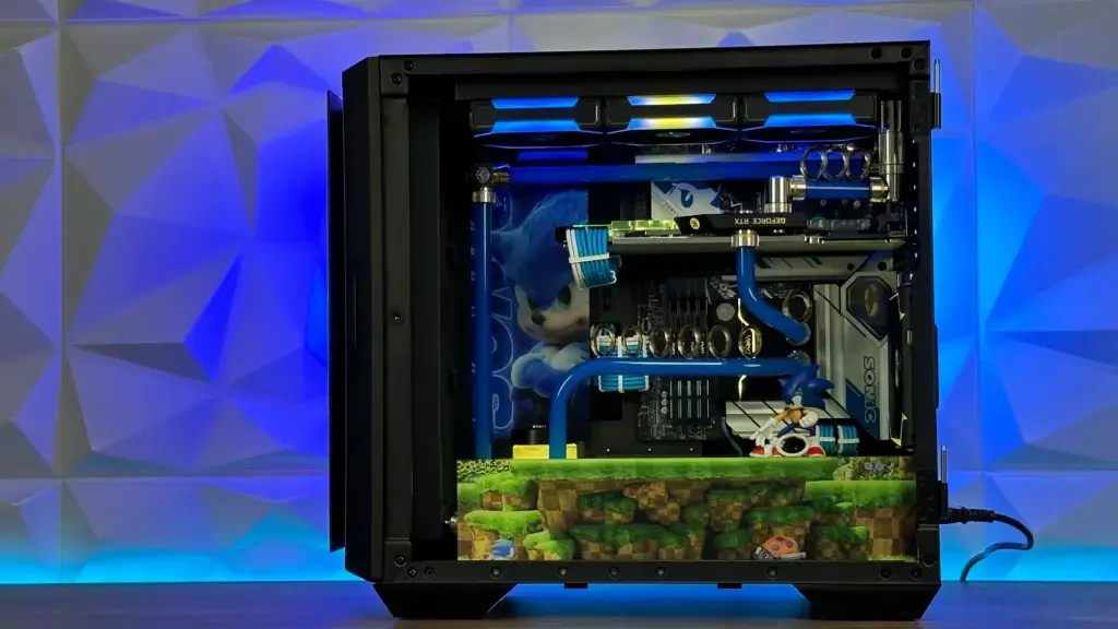 Inside view of the Sonic mod showing blue water-cooling tubes, themed artwork, and an acrylic Green Hill Zone base.