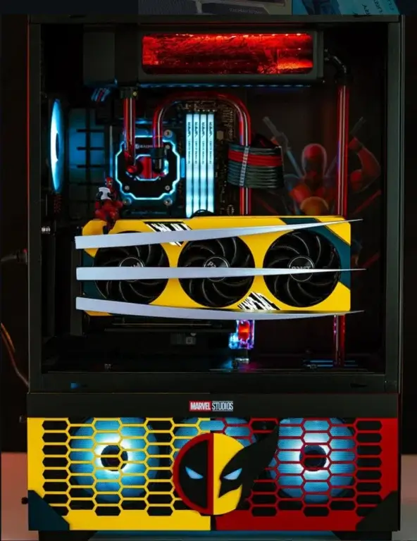 Internal view of Deadpool and Wolverine themed PC build by Quantum Labs showing cooling loop and graphics card