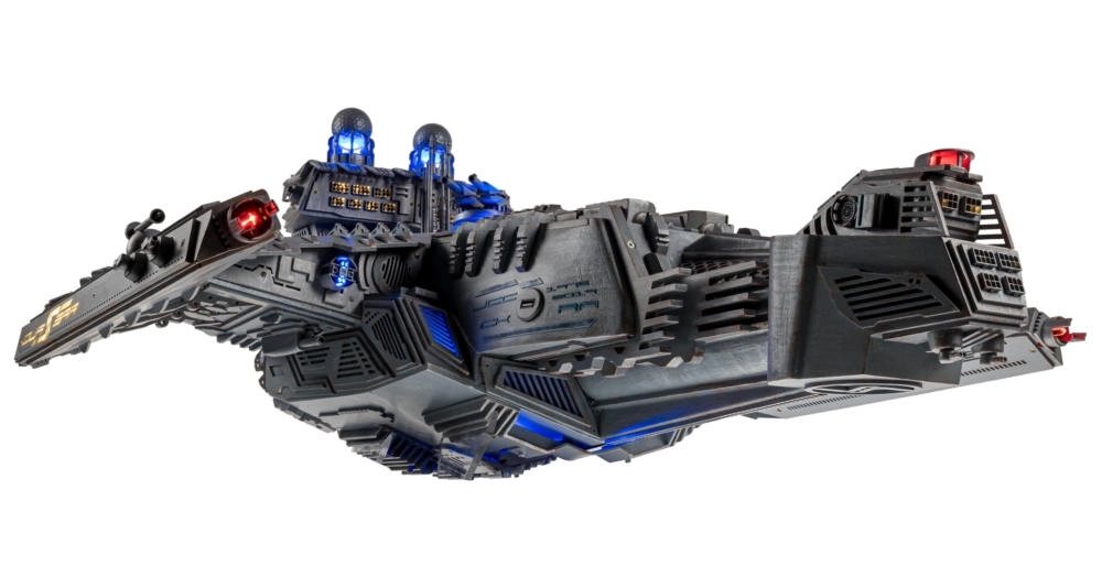 A low-angle side perspective of The Quasar, emphasizing the scale of the wings and the custom-painted industrial aesthetic of the build.