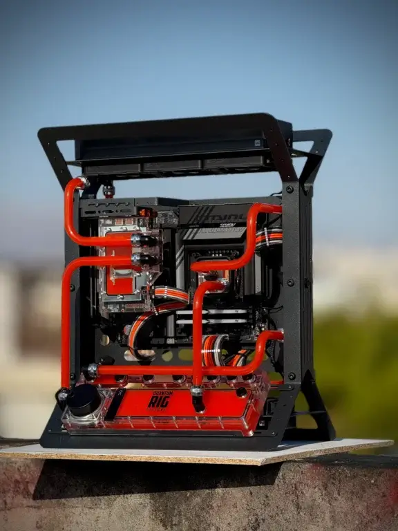 Detailed view of Project Apex liquid cooling loop with red hard tubing by Quantum Rig Designs