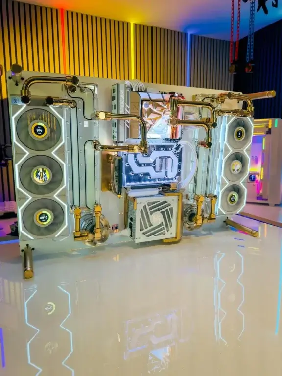 Overbuilt water-cooled PC build with gold hard tubing and custom radiator configuration